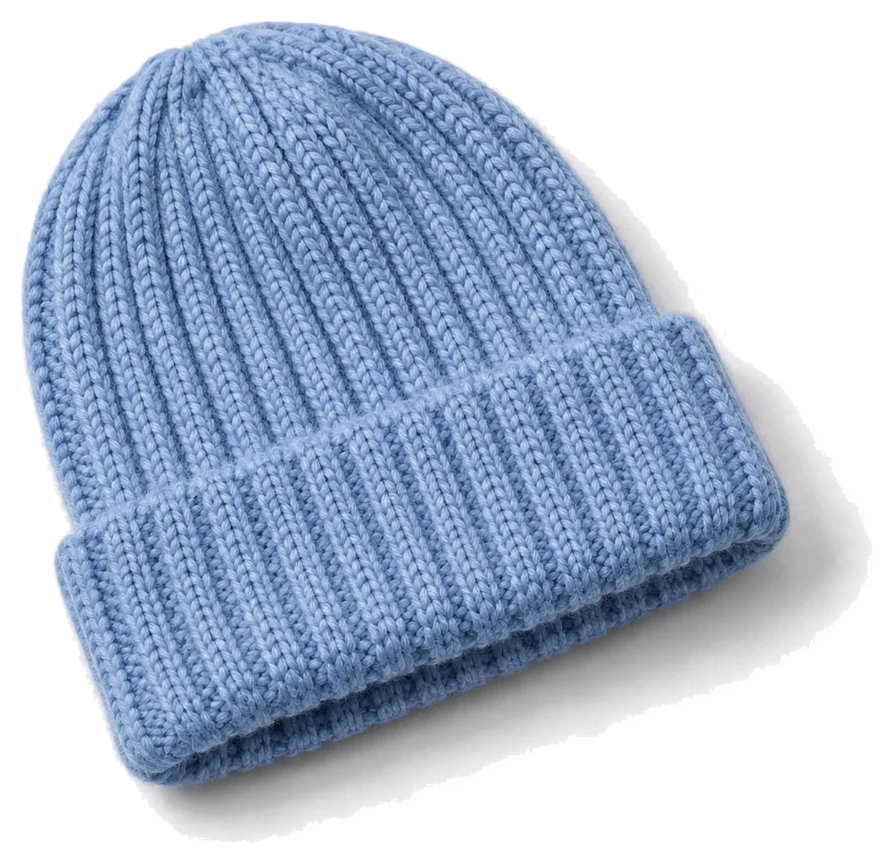 Cornflower-blue ribbed beanie on a pale studio background, product concept