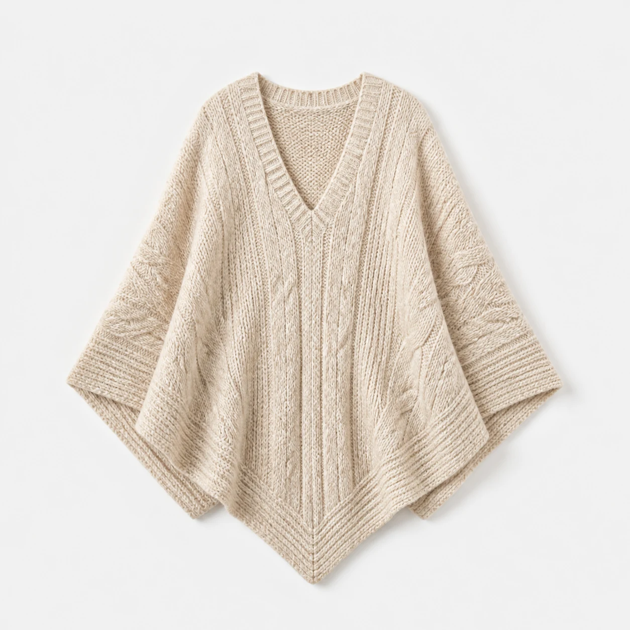 Oatmeal knitted poncho on a pale studio background, product concept